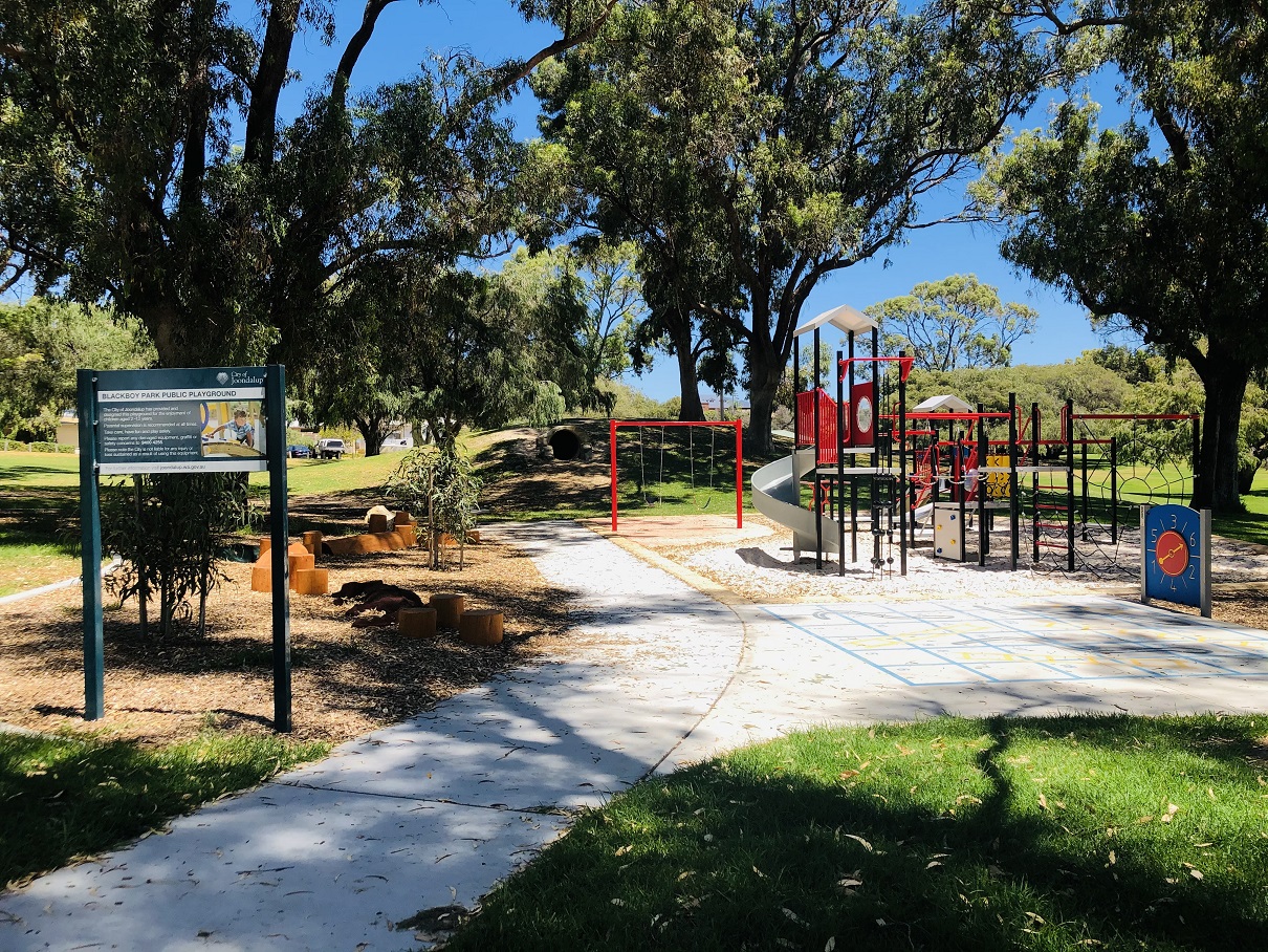 Small shady playground in a quiet suburban area with all the facilities