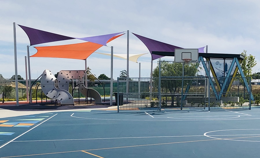 Small suburban playground with a big multi-sports court
